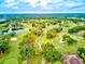 Expansive golf course with mature trees, serene ponds and meticulously maintained greens, under a partly cloudy sky at 54 Camino Real Blvd # 504, Howey In The Hills, FL 34737