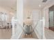 Bright hallway offers a view of the dining area, front door, and access to the upstairs bedrooms at 54 Camino Real Blvd # 504, Howey In The Hills, FL 34737