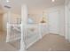 Hallway with white staircase and chandelier at 54 Camino Real Blvd # 504, Howey In The Hills, FL 34737