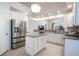 Bright, open kitchen features granite countertops, stainless steel appliances, and an island for extra prep space at 54 Camino Real Blvd # 504, Howey In The Hills, FL 34737