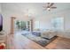 Bright living room featuring wood floors, a ceiling fan and a sliding glass door at 54 Camino Real Blvd # 504, Howey In The Hills, FL 34737