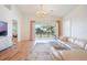 Spacious living room with hardwood floors, a stylish chandelier, and sliding doors to an outdoor patio at 54 Camino Real Blvd # 504, Howey In The Hills, FL 34737