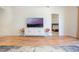 Bright living room showcases hardwood floors, a sleek entertainment center, and a view into the bedroom at 54 Camino Real Blvd # 504, Howey In The Hills, FL 34737
