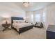 This main bedroom features a large bed, big windows and chair seating at 54 Camino Real Blvd # 504, Howey In The Hills, FL 34737