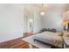 Spacious main bedroom with chandelier, hardwood floors, and ensuite bathroom at 54 Camino Real Blvd # 504, Howey In The Hills, FL 34737