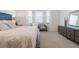 Main bedroom features a large bed, big windows, and a modern dresser at 54 Camino Real Blvd # 504, Howey In The Hills, FL 34737