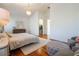 Comfortable bedroom with sleek wood floors, chandelier, and a cozy gray ottoman at 54 Camino Real Blvd # 504, Howey In The Hills, FL 34737