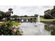 Scenic water view features a tranquil pond with a fountain, bridge and lush greenery, creating a serene and picturesque setting at 54 Camino Real Blvd # 504, Howey In The Hills, FL 34737
