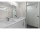 A modern bathroom featuring double sinks, quartz countertops, a glass enclosed tiled shower at 565 Malauka Radl, Ocklawaha, FL 32179