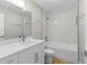 A modern bathroom featuring quartz countertops, a shower with glass door, and a soaking tub at 565 Malauka Radl, Ocklawaha, FL 32179