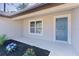 Detail shot of the front entry with manicured landscaping and a modern door design for a fresh, inviting feel at 565 Malauka Radl, Ocklawaha, FL 32179