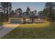 Charming single-story home featuring a lush front lawn and attached two-car garage, perfect for suburban living at 565 Malauka Radl, Ocklawaha, FL 32179