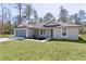Attractive home with a neatly maintained lawn and a complementary color scheme, enhancing curb appeal at 565 Malauka Radl, Ocklawaha, FL 32179