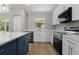 Well-equipped kitchen featuring stainless steel appliances, white cabinets, and a spacious countertop area for cooking at 565 Malauka Radl, Ocklawaha, FL 32179