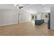 Open-concept kitchen and living area with island, wood floors, and sliding door at 565 Malauka Radl, Ocklawaha, FL 32179
