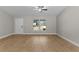 Living Room with ceiling fan and large windows overlooking front yard at 565 Malauka Radl, Ocklawaha, FL 32179