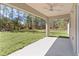 Covered patio with view of green grass at 565 Malauka Radl, Ocklawaha, FL 32179