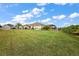 Expansive lawn in backyard is lush and well-maintained with mature landscaping at 712 Krietemeyer Path, The Villages, FL 32163
