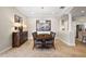 Well-lit dining room with a decorative chandelier, an elegant table, and views of the kitchen at 712 Krietemeyer Path, The Villages, FL 32163
