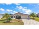Charming home with beautifully landscaped front yard, manicured lawn, and welcoming curb appeal at 712 Krietemeyer Path, The Villages, FL 32163