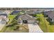 Beautiful single-story home with a manicured lawn, elegant landscaping, and a brick-paved driveway at 712 Krietemeyer Path, The Villages, FL 32163