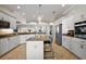 Spacious kitchen with granite countertops, stainless steel appliances, and an open floor plan at 712 Krietemeyer Path, The Villages, FL 32163