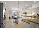 Modern kitchen with granite countertops, stainless steel appliances, and bright, natural lighting at 712 Krietemeyer Path, The Villages, FL 32163