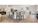 Open-concept kitchen with granite countertops, stainless steel appliances, and counter seating at 712 Krietemeyer Path, The Villages, FL 32163