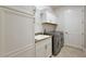 Spacious laundry room with cabinets, a sink, counter space, and modern washer and dryer at 712 Krietemeyer Path, The Villages, FL 32163