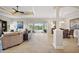 Open concept living room featuring high ceilings, neutral paint, tile floors, and seamless access to the pool area at 712 Krietemeyer Path, The Villages, FL 32163