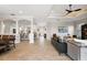 Bright and open-concept living area with elegant columns and neutral tones throughout the home at 712 Krietemeyer Path, The Villages, FL 32163