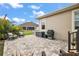 Paver patio with outdoor furniture and grill, perfect for entertaining and relaxing outdoors at 712 Krietemeyer Path, The Villages, FL 32163