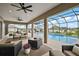 A screened-in patio with comfortable seating overlooks a beautiful pool and lush backyard at 712 Krietemeyer Path, The Villages, FL 32163
