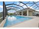 Screened-in pool area with a covered patio and ample seating provides a perfect oasis for relaxation at 712 Krietemeyer Path, The Villages, FL 32163