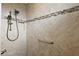 Tiled shower featuring a rainfall showerhead, handheld sprayer, a built-in niche, and a grab bar at 712 Krietemeyer Path, The Villages, FL 32163