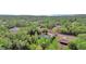 An aerial view of the wooded neighborhood with a clear view of nearby lake at 73 Bay Dr, Ocklawaha, FL 32179