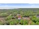 Scenic aerial view of homes nestled in a lush, wooded landscape near a tranquil lake at 73 Bay Dr, Ocklawaha, FL 32179