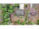 Overhead view of a home with a long driveway surrounded by green trees and neighboring houses at 73 Bay Dr, Ocklawaha, FL 32179