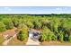 An aerial view shows the property with a long drive and beautiful treeline at 73 Bay Dr, Ocklawaha, FL 32179