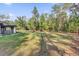 Expansive backyard view complete with a screened in porch area at 73 Bay Dr, Ocklawaha, FL 32179