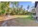 Sprawling green backyard with a storage trailer and view of the house at 73 Bay Dr, Ocklawaha, FL 32179
