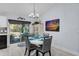 Charming dining area featuring a round table with gray chairs and sliding glass doors to a patio at 73 Bay Dr, Ocklawaha, FL 32179