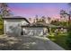 Charming home with a three-car garage and beautiful twilight sky at 73 Bay Dr, Ocklawaha, FL 32179