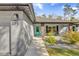 Inviting front entrance with a turquoise-colored door and stone accents at 73 Bay Dr, Ocklawaha, FL 32179