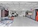 Large garage equipped with ample storage solutions, fitness equipment, and durable epoxy flooring at 73 Bay Dr, Ocklawaha, FL 32179
