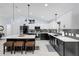 Well-appointed kitchen with sleek black and white cabinetry, island with stools, and stainless steel appliances at 73 Bay Dr, Ocklawaha, FL 32179