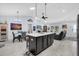 Open kitchen and dining area with an island and modern lighting at 73 Bay Dr, Ocklawaha, FL 32179