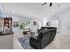 Bright living room with contemporary furniture and a large window at 73 Bay Dr, Ocklawaha, FL 32179