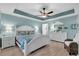 Inviting main bedroom with light blue walls, white furniture, and a tropical bedding at 73 Bay Dr, Ocklawaha, FL 32179