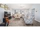 Comfortable living room featuring neutral walls, gray flooring, and cozy seating area at 781 Nancy Dr, The Villages, FL 32163